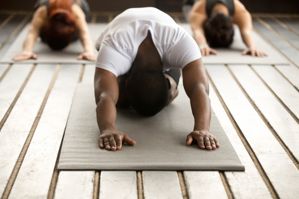 A small group resting in child’s pose on their mats