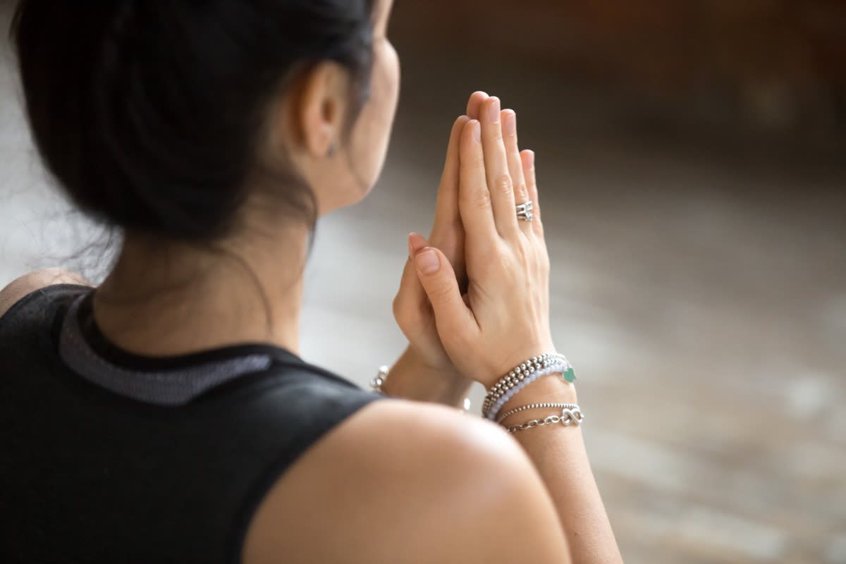 Hands pressed together in a namaste gesture